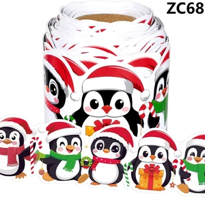 Close-up of Christmas penguin sticker roll with cute cartoon gift and candy cane designs