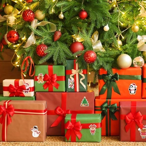 Detailed view of Christmas gift boxes with festive cartoon stickers and satin ribbons