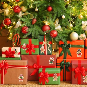 Detail of Christmas stickers with gingerbread and snowman on festive gift boxes