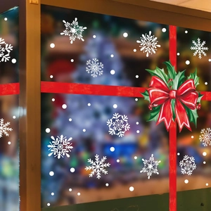 Christmas window decals featuring red ribbon bow, holly leaves and white snowflakes
