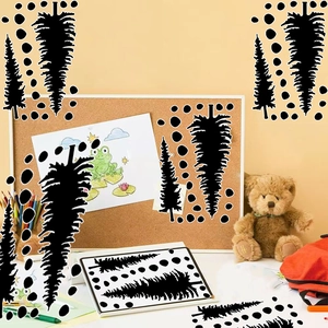 Detail of black vinyl pine tree silhouettes and dots on a creative cork message board
