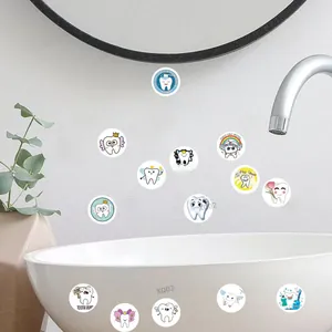 Detail view of cute cartoon dental stickers with tooth fairy designs on a bathroom wall