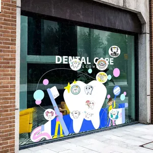 Detail view of dental care window stickers featuring cartoon teeth and toothbrush graphics