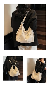 Detail view of cream shoulder bag with braided rope charm and versatile straps