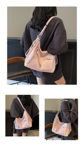 Detail view of pink large capacity tote bag featuring multi-pocket design and soft leather texture