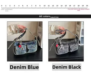 Detail view of denim underarm bags in blue and black with adjustable buckle straps