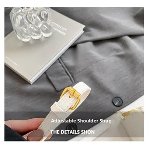 Detail of white lychee leather adjustable shoulder strap with premium gold buckle