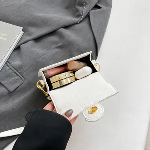 Mini white leather crossbody bag interior capacity display with lipstick and cushion