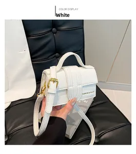 Detailed view of white mini crossbody bag featuring pebble leather and gold hardware