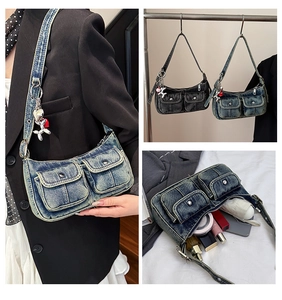 Internal storage detail of denim shoulder bag showing space for phone and makeup