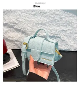 Detail of light blue lychee pattern mini crossbody bag with gold fashion buckle