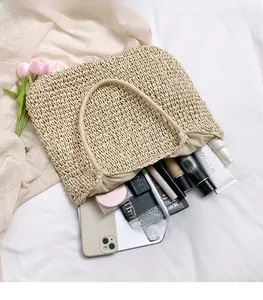 Detailed top view of a large beige woven tote bag showing spacious interior with essentials