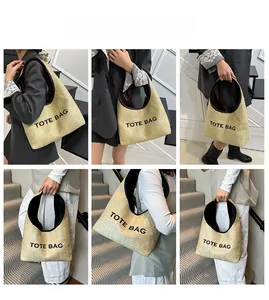 Detail view of woven straw tote bag featuring contrast leather trim and black printed text