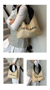 Detail of raffia woven tote bag showing beige straw texture and black printed logo