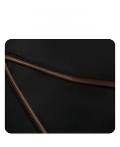 Detail of black fabric backpack with stylish brown leather contrast piping accents