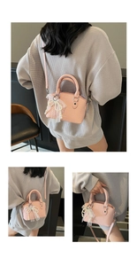 Close-up of pink litchi grain leather bag with decorative pearl and lace bow charm