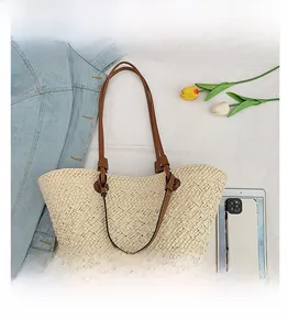 Size comparison between a woven straw tote bag and a tablet on a summer background