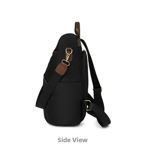 Side view of black nylon travel backpack with brown leather trim and golden metal hooks