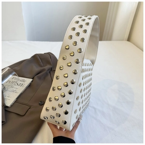 Close-up of white leather hobo bag with silver metal studs and curved shoulder strap