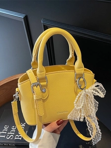 Chic yellow lychee texture bucket bag with pearl bow charm and adjustable strap