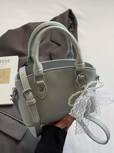 Pale mint green lychee textured bucket bag with pearl lace bow and dual handles
