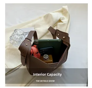Top view of brown leather bucket bag showing large capacity for tablet and phone