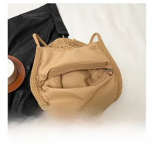 Detailed interior of woven straw tote bag featuring zipper pocket and cotton lining