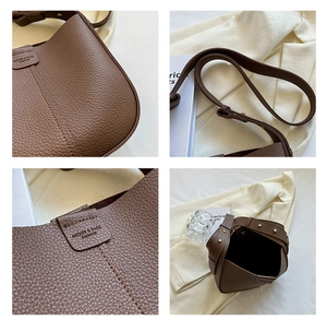 Detailed views of brown lychee-textured leather crossbody bag with adjustable strap and logo