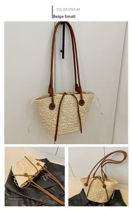Detail view of small beige straw tote bag with brown leather handles and color display