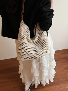 Handwoven cream tote bag with hollow out mesh texture and brown leather strap