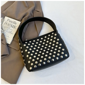 Detail view of black leather shoulder bag featuring stylish silver metal rivet studs