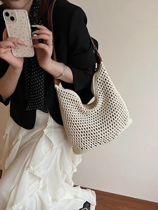 Large beige woven shoulder bag with brown leather strap for summer beach vacations