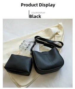 Close-up of black lychee grain saddle bag with matching small coin purse and strap