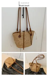 Detail view of khaki straw tote bag with brown leather straps and drawstring closure