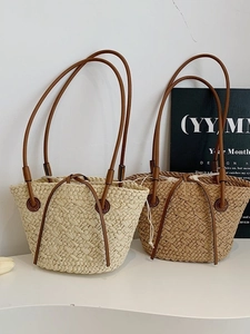 Handwoven straw tote bag with leather straps and drawstring liner for beach and vacation