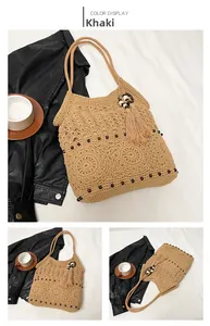 Detail view of khaki hollow crochet tote bag with fringe tassels and wooden beads