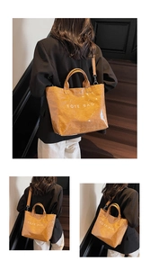Detail of glossy brown tote bag with wrinkled texture and white TOTE BAG text print
