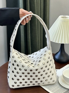 White studded crescent shoulder bag with silver metal rivets and grainy leather texture