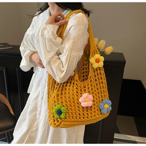 Detail of yellow hollow crochet tote bag with vibrant 3D floral embroidery appliques