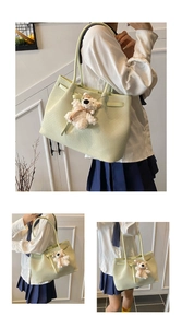 Detail of light green woven tote bag with cute plush bear charm and spacious interior