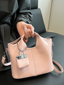 Pink minimalist PU leather handbag with matching mini charm and crossbody strap