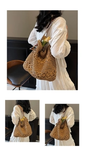 Detail of hollow woven straw tote bag featuring a colorful ethnic style wide shoulder strap