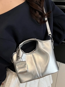 Chic silver metallic Hobo bag with adjustable strap and matching mini charm attachment