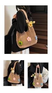 Detail of hand-crocheted beige tote bag featuring colorful 3D floral embroidery