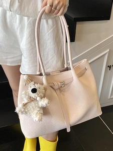 Pink woven bucket tote bag with cute bear charm and cross-body strap for daily use