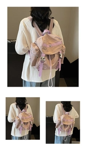 Detail of light purple nylon backpack with drawstring closure and secure buckle strap