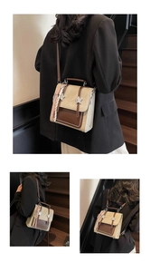 Detail of a beige and brown crossbody bag featuring star hardware and woven strap