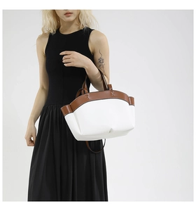 Chic two-tone white and brown large tote bag shown on a model with a black dress