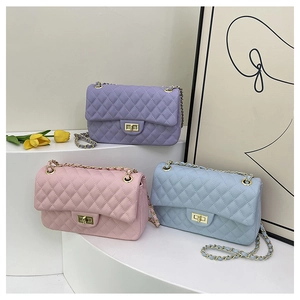 Detailed view of quilted leather chain bags in purple, pink, and light blue colors