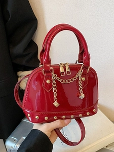 Red patent leather shell bag with gold studs, chain, and dice charms for women